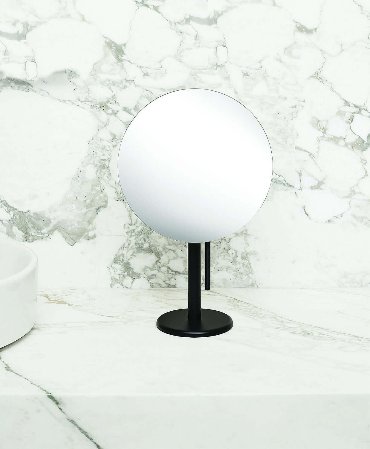 The handle beneath the mirror face of the Epure mirror allows for adjustment of the viewing angle without touching the silver-backed glass 9" mirror.