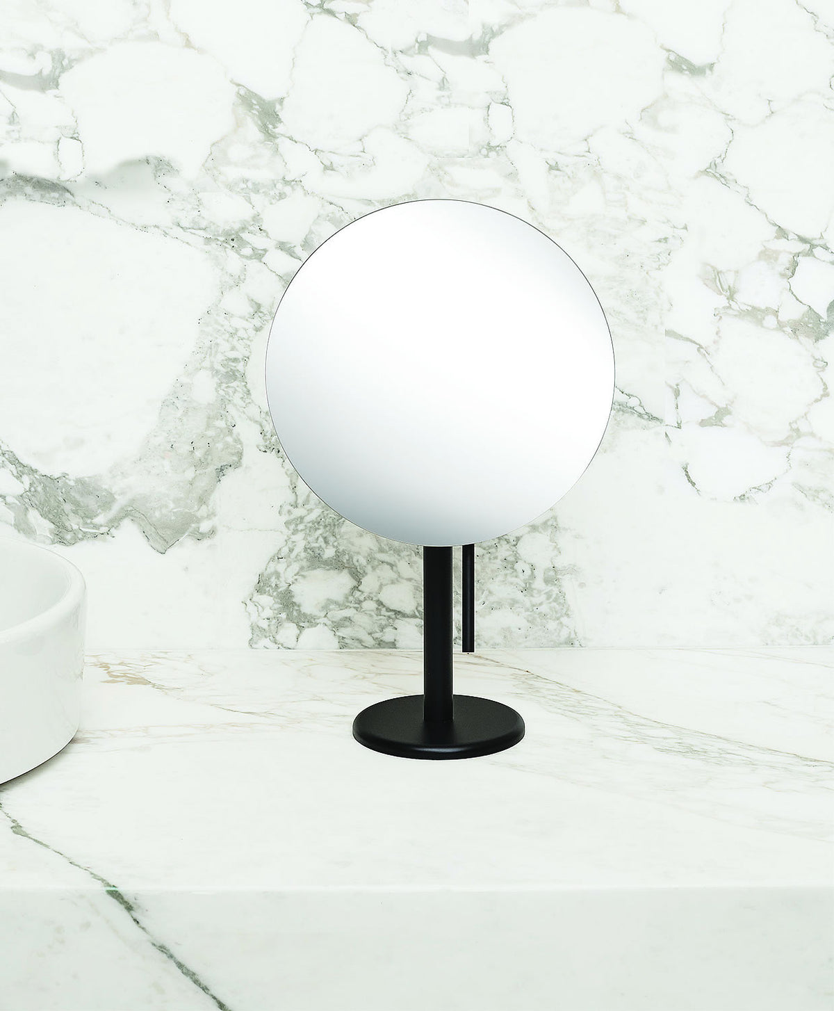 The handle beneath the mirror face of the Epure mirror allows for adjustment of the viewing angle without touching the silver-backed glass 9" mirror.