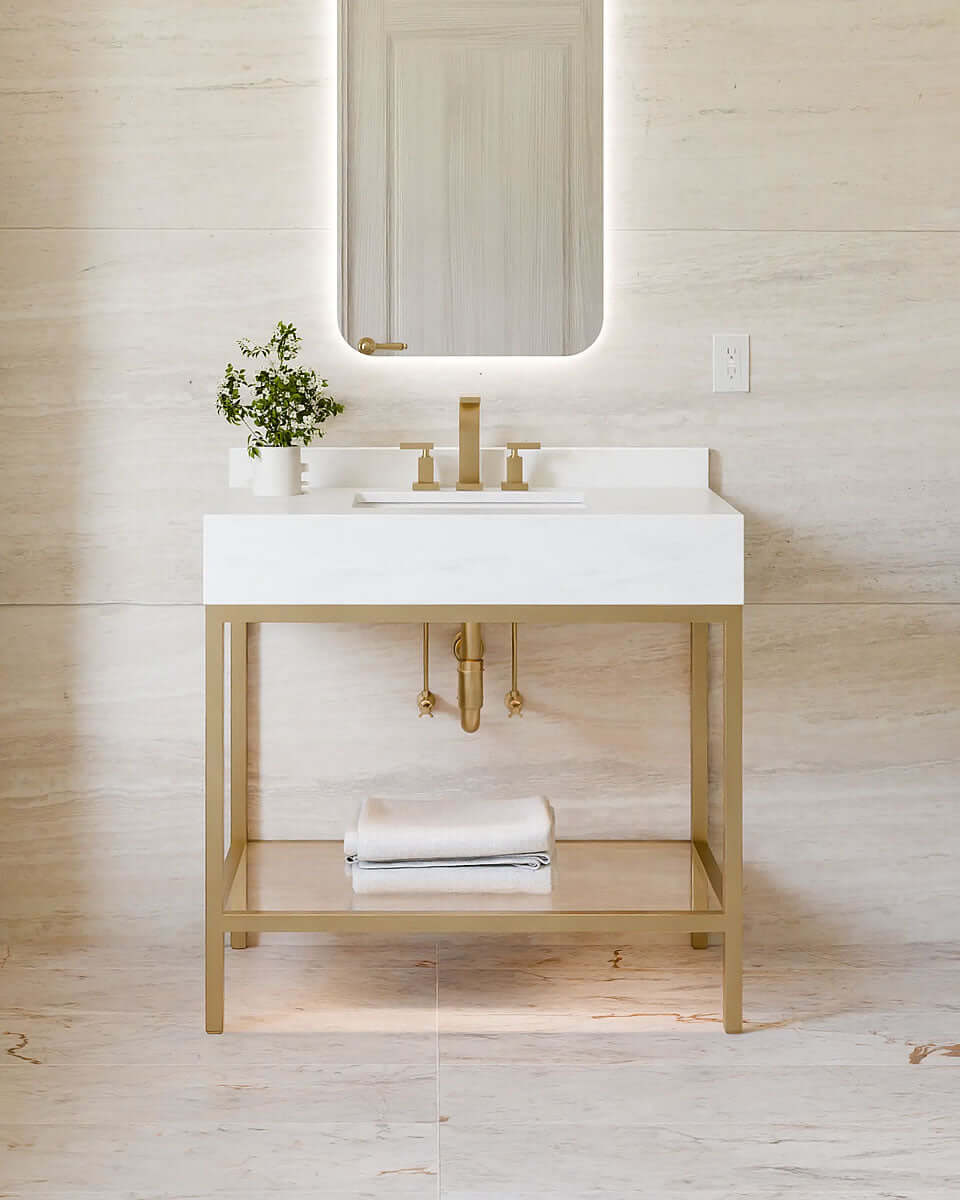 Savannah by Electric Mirror in Brushed Brass. The waterfall countertop is Cararra Quartz.