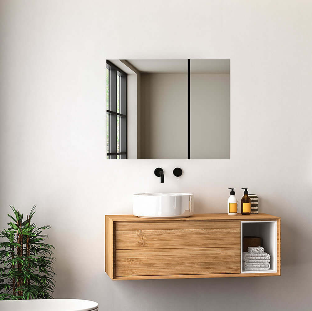 Aquadom Royale 3-Door Medicine Cabinet above modern vanity with mirror and sink in stylish bathroom.